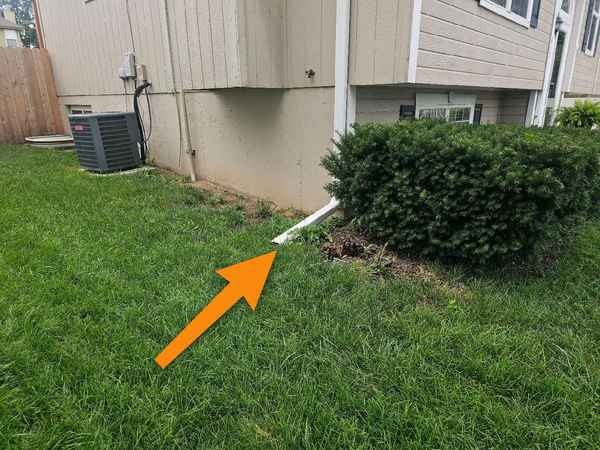 Downspout draining at the foundation found during a home inspection in Blue Springs, MO