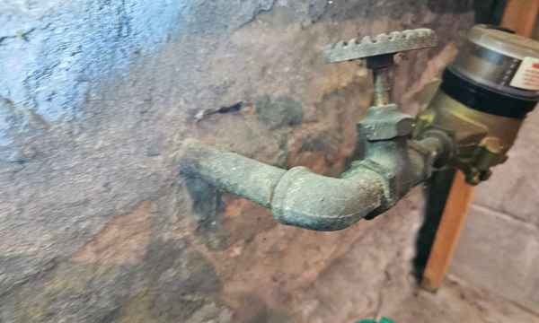 Corrosion on a galvanized water supply pipe near the main shutoff found during a home inspection in Independence, MO