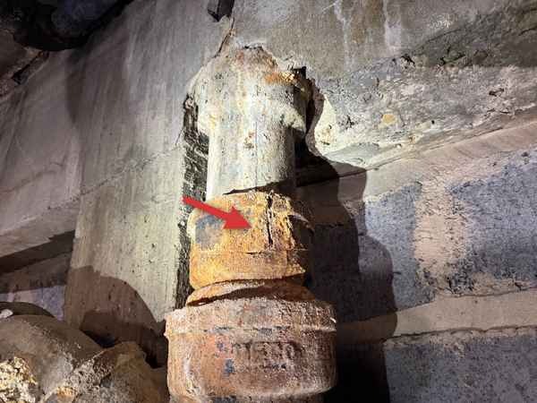 Cracked cast-iron drain pipe found during an investor inspection in the Kansas City area