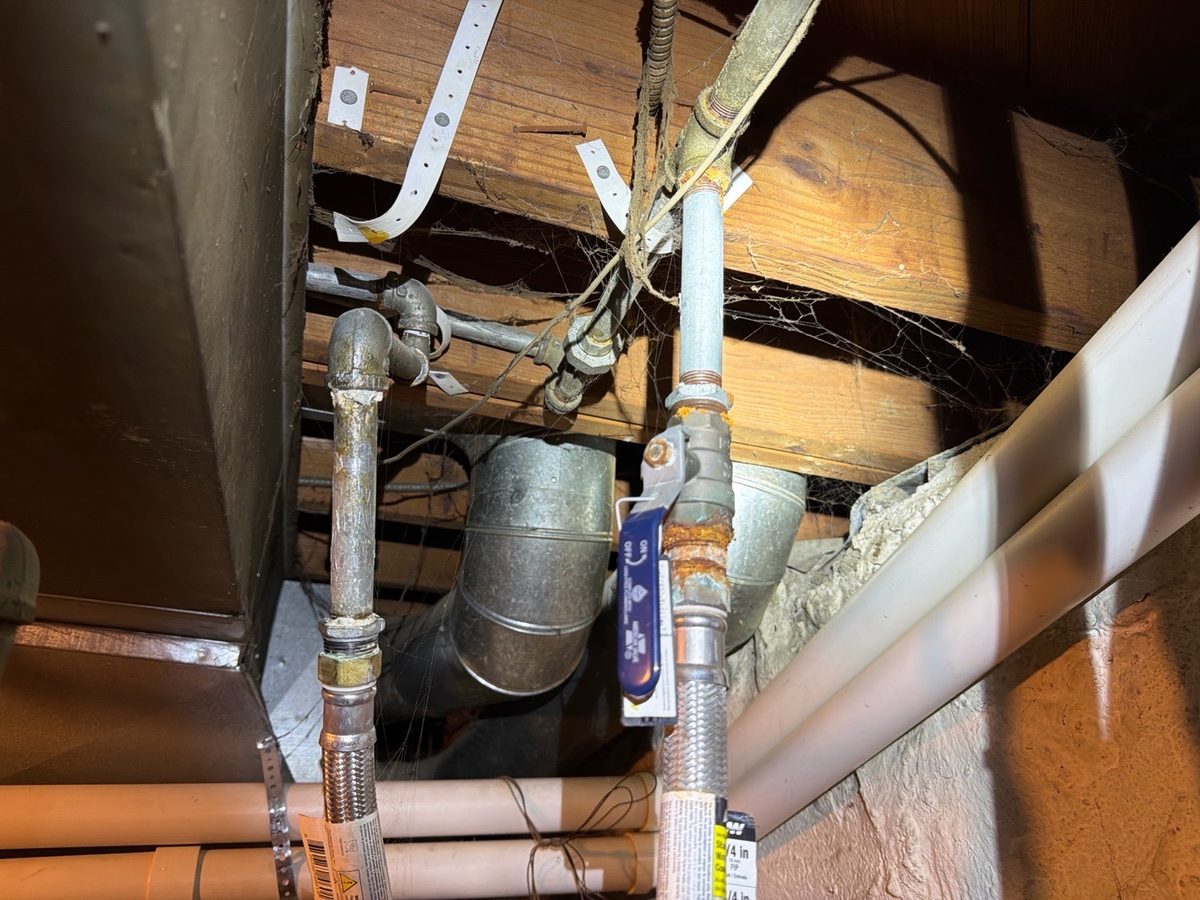 Rust and corrosion on galvanized water supply piping at a shutoff valve found during a home inspection in Kansas City, KS