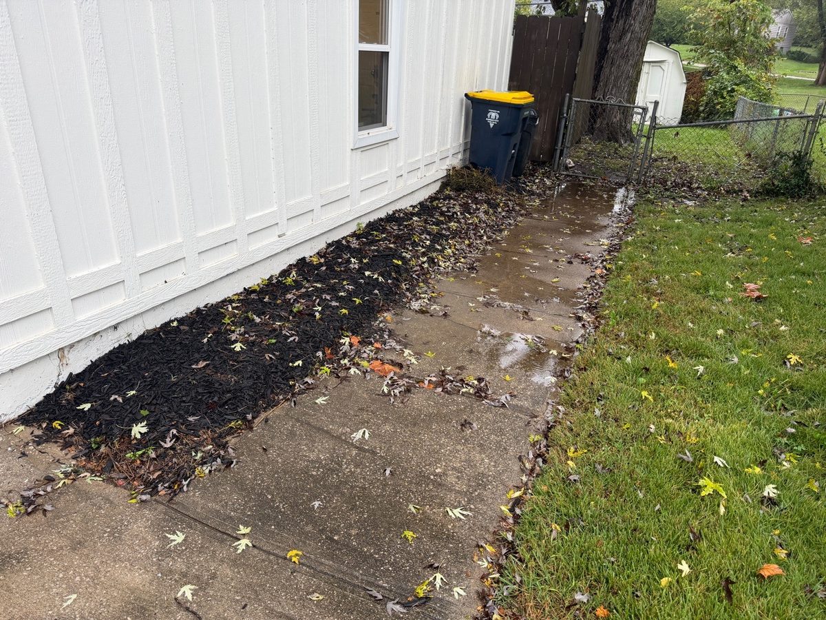Negative grading and a wet walkway sloping toward a home's foundation found during a home inspection in Kansas City, MO
