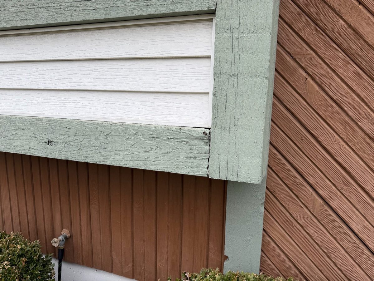 Weathered, split wood trim at a siding corner and bump-out found during a home inspection in Lenexa, KS
