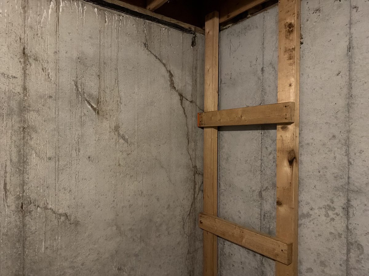 Diagonal and vertical cracks in a poured concrete basement wall found during a home inspection in Liberty, MO
