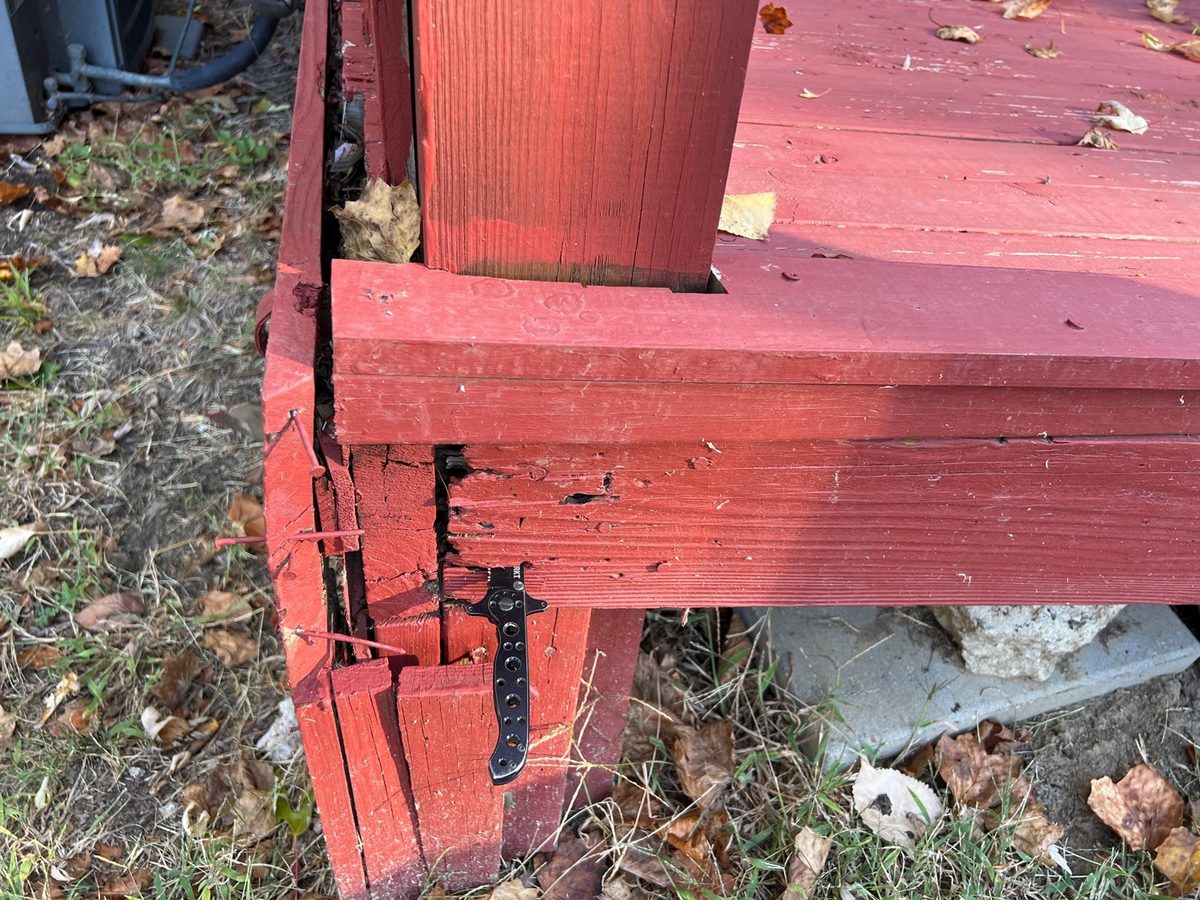 Rot on a deck rim board and post base found during a home inspection in Riverside, MO