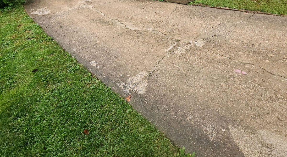Cracking and deterioration on a concrete driveway found during a home inspection in Olathe, KS