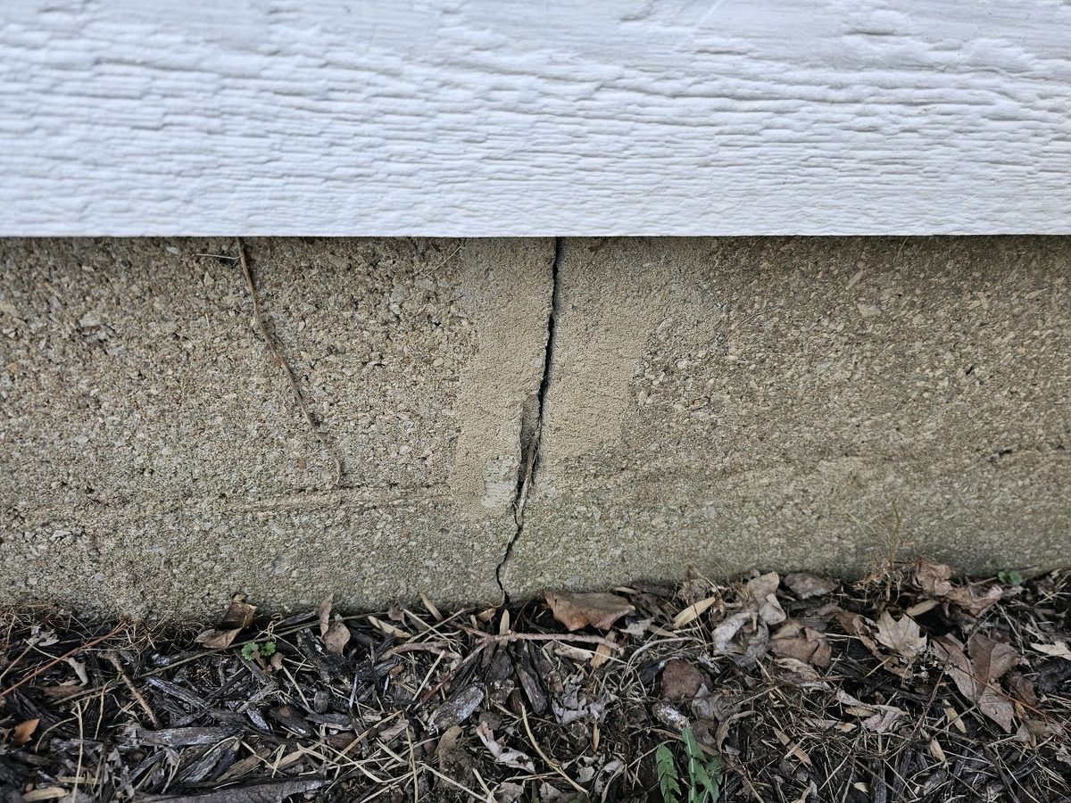 New crack through an earlier patch on an exterior block foundation found during a home inspection in Overland Park, KS