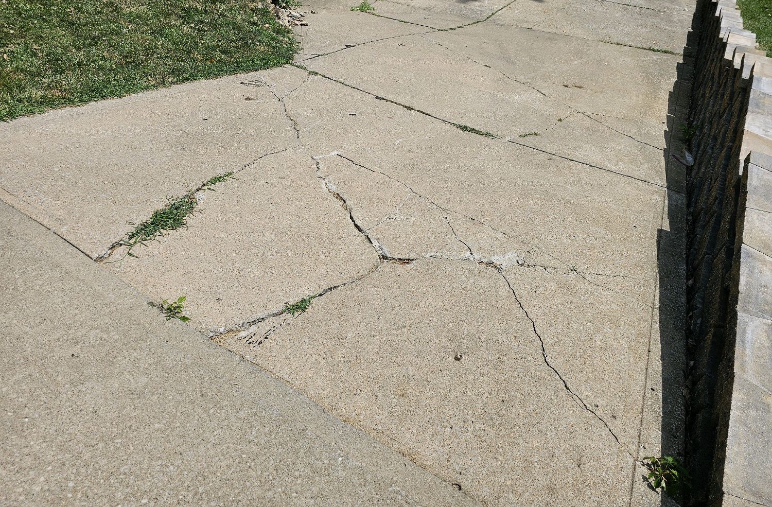 Settlement cracks on a concrete driveway found during a home inspection in Parkville, MO