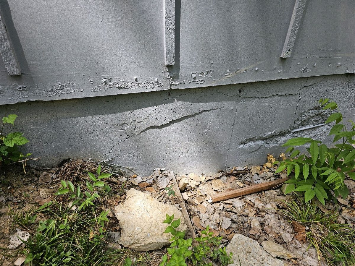 Horizontal cracks and spalling on an exterior foundation wall found during a home inspection in Parkville, MO